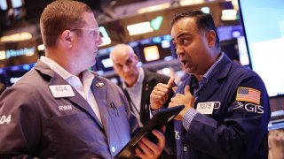 Traders work on the floor of the New York Stock Exchange during morning trading on July 31, 2024.