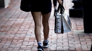 A shopper carries a Lululemon bag in the Georgetown neighborhood of Washington, DC, US, on Tuesday, July 30, 2024. Consumers have continued to spend and make major purchases, which is one of the key reasons economists are hopeful the Fed can tame inflation without sparking a recession. Photographer: Tierney L. Cross/Bloomberg via Getty Images