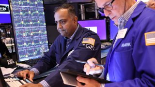 Traders work on the floor of the New York Stock Exchange during morning trading on Aug. 6, 2024.