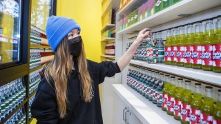 Mimi Lam, co-founder and chief executive officer of Superette, arranges cannabis-infused beverages at the Superette Sip ‘N’ Smoke cannabis dispensary in Toronto, Ontario, Canada, on Monday, Oct. 25, 2021. 