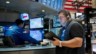 Traders work the floor of the New York Stock Exchange on August 16, 2024. 