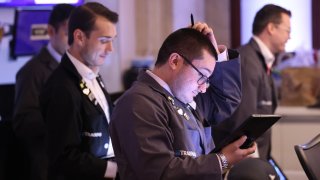 Traders work on the floor of the New York Stock Exchange during morning trading on Aug. 20, 2024.