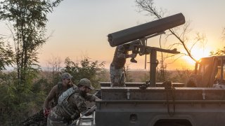 Ukrainian soldiers prepare a vehicle adapted to fire helicopter shells on Aug. 19, 2024. 