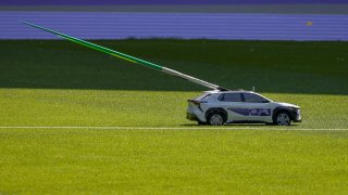 A mini-car carrying the javelins is seen during a test event for the 2024 Paris Olympics.