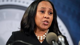 FILE - Fulton County District Attorney Fani Willis speaks during a news conference, Aug. 14, 2023, in Atlanta. People connected with former President Donald Trump’s legal cases have been inundated with threats. In Atlanta, Willis, who brought criminal charges against Trump and 18 other people alleging they schemed to illegally overturn the 2020 election results in Georgia, is known to be accompanied by round-the-clock bodyguards.