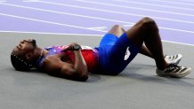 COVID-stricken Noah Lyles, of the United States, lies on the track after competing in the men's 200-meter final at the 2024 Summer Olympics, Thursday, Aug. 8, 2024, in Saint-Denis, France. Lyles said he tested positive for COVID two days before he finished third in the 200-meter final. (AP Photo/Petr David Josek)