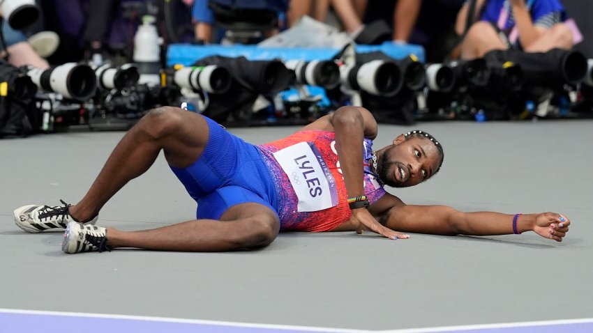 Noah Lyles, of the United States, lays on the track after the men’s 200-meter final at the 2024 Summer Olympics, Thursday, Aug. 8, 2024, in Saint-Denis, France. (AP Photo/Matthias Schrader)