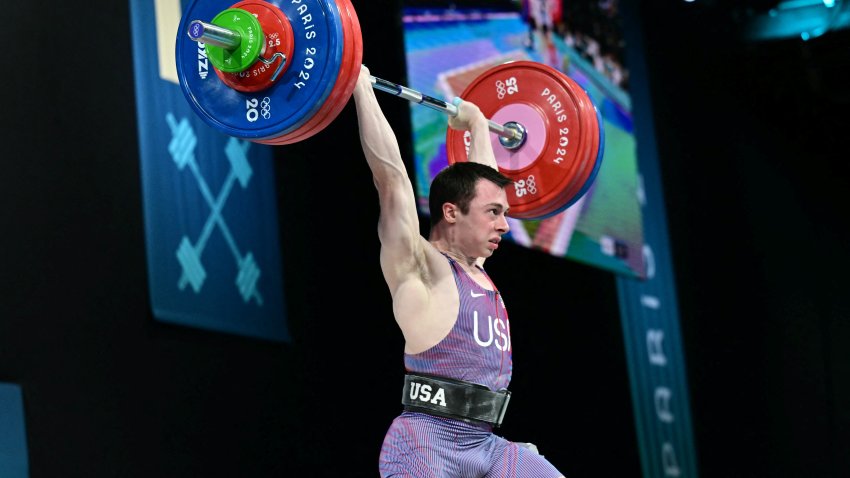 US’ Hampton Morris competes in the men’s -61kg weightlifting event during the Paris 2024 Olympic Games at the South Paris Arena in Paris, on August 7, 2024. (Photo by Miguel MEDINA / AFP) (Photo by MIGUEL MEDINA/AFP via Getty Images)