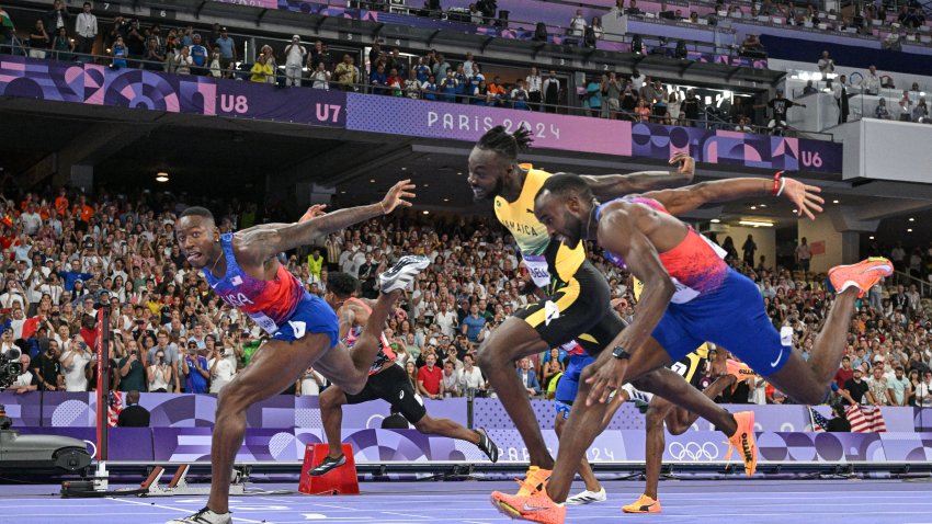 Grant Holloway crosses the finish line