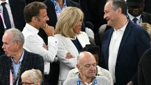 French President Emmanuel Macron (L), his wife Brigitte Macron (C) speak with US second gentleman Doug Emhoff (R) as they attend  the men's Gold Medal basketball match between France and USA during the Paris 2024 Olympic Games at the Bercy  Arena in Paris on August 10, 2024. (Photo by Paul ELLIS / AFP) (Photo by PAUL ELLIS/AFP via Getty Images)