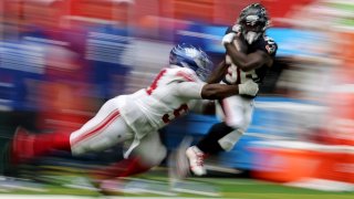 HOUSTON, TEXAS – AUGUST 17: J.J. Taylor #38 of the Houston Texans runs the ball in the second half while defended by Elijah Chatman #94 of the New York Giants during the preseason game at NRG Stadium on August 17, 2024 in Houston, Texas.