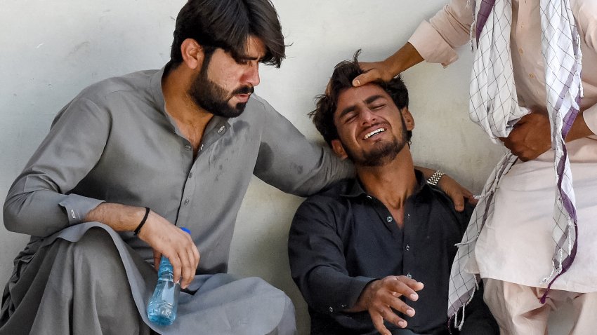 A man (C) mourns the death of his father, who died in a separatist militants shooting, at a hospital in Quetta on August 26, 2024. Separatist militants killed at least 39 people in “coordinated” attacks in southwestern Pakistan on August 26, that largely targeted ethnic Punjabis, government officials said. (Photo by Banaras KHAN / AFP) (Photo by BANARAS KHAN/AFP via Getty Images)