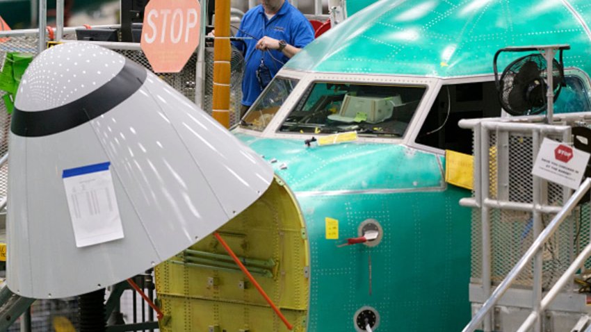 A Boeing employees works outside of the cockpit of a Boeing 737 MAX 8 airplane in the company’s factory, on March 27, 2019 in Renton, Washington.