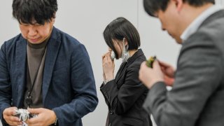 Participants taste onigiri at a product meeting for 7-Eleven Japan in Tokyo on Jan. 23, 2024. Staff and suppliers gathered to discuss flavors, textures and fillings for the Japanese riceballs, one of 7-Eleven’s most important products, with more than 2 billion sold each year.