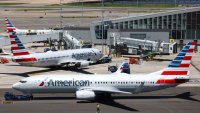 An American Airlines’ Embraer E175LR (front), an American Airlines’ Boeing 737 (C) and an American Airlines’ Boeing 737 are seen parked at LaGuardia Airport in Queens, New York on May 24, 2024. 