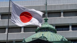 The Bank of Japan is largely expected to hold interest rates steady at the end of its 2-day meeting ending June 14, 2024. Seen here, the Japanese flag flying high at the BOJ headquarters in Tokyo.