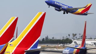 A Southwest Airlines plane takes off from Hollywood Burbank Airport above other Southwest planes on July 25, 2024 in Burbank, California. 