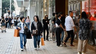 Tourists from mainland cities enter a Louis Vuitton store at Tsim Sha Tsui on June 5, 2024 in Hong Kong. 