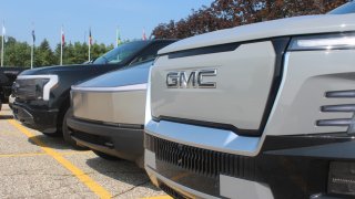 Fronts of the GMC Sierra Denali,Tesla Cybertruck and Ford F-150 Lightning EVs (left to right).