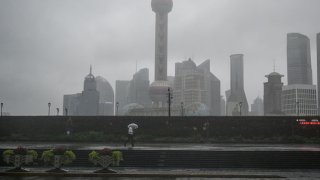 A man walks along The Bund during the passage of Typhoon Bebinca in Shanghai on September 16, 2024. The strongest storm to hit Shanghai in over 70 years made landfall on September 16, state media reported, with flights cancelled and highways closed as Typhoon Bebinca lashed the city with strong winds and torrential rains.