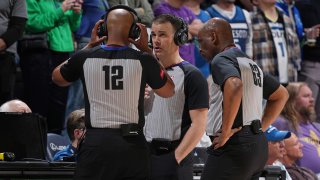 NBA referees Mark Lindsay, CJ Washington and Derek Richardson watch a replay