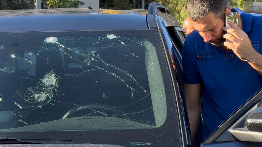 A police officer inspects a car in which a hand-held pager exploded