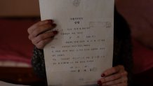 Yooree Kim holds adoption documents