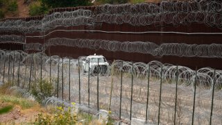 FILE - A vehicle drives along the U.S. side of the US-Mexico border