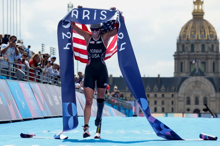 Team USA's Grace Norman celebrates as she crosses the finish line to win the Para Triathlon Women's PTS5 event during the Paris 2024 Paralympic Games at the Pont Alexandre III in Paris on September 2 2024