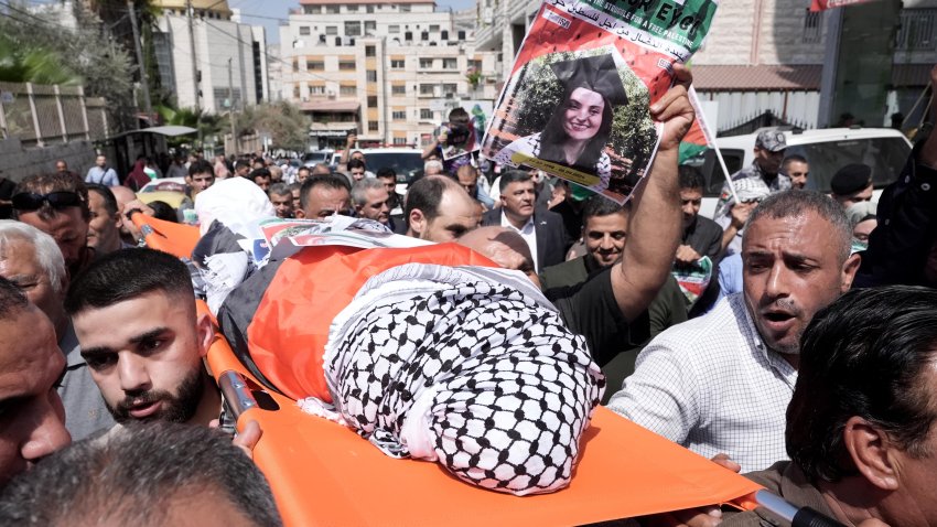 NABLUS, WEST BANK - SEPTEMBER 09: The body of Turkish-American activist Aysenur Ezgi Eygi, who was killed by Israeli forces on Friday, carried on shoulders, wrapped in the Palestinian flag, with the head covered by the traditional Palestinian keffiyeh during funeral procession in the West Bank city of Nablus on September 09, 2024. Eygi's body was taken from Rafidiyeh Hospital in Nablus with international solidarity activists, Palestinians, Turkiye's Consul General in Jerusalem, Ambassador Ismail Cobanoglu, Nablus Governor Ghassan Daghlas, and various civil society representatives.