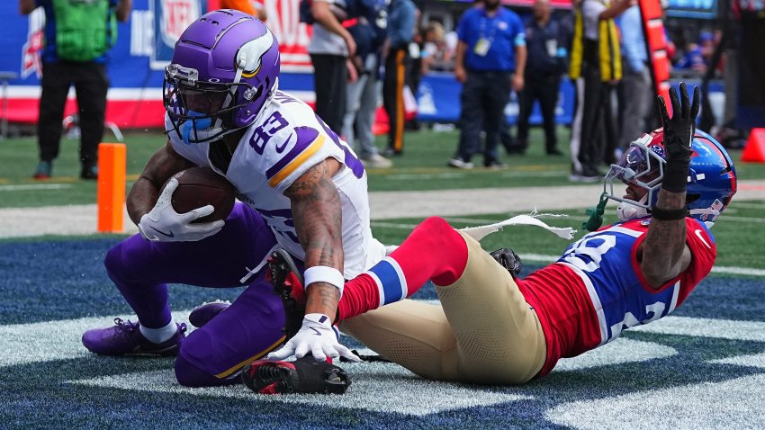 Jalen Nailor #83 of the Minnesota Vikings catches a touchdown pass over Cor'Dale Flott #28 of the New York Giants in the third quarter of the game at MetLife Stadium on September 08, 2024 in East Rutherford, New Jersey. (Photo by Mitchell Leff/Getty Images)