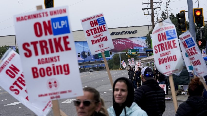 Boeing workers wave picket signs as they strike after union members voted to reject a contract offer, Sunday, Sept. 15, 2024, near the company’s factory in Everett, Wash. (AP Photo/Lindsey Wasson)