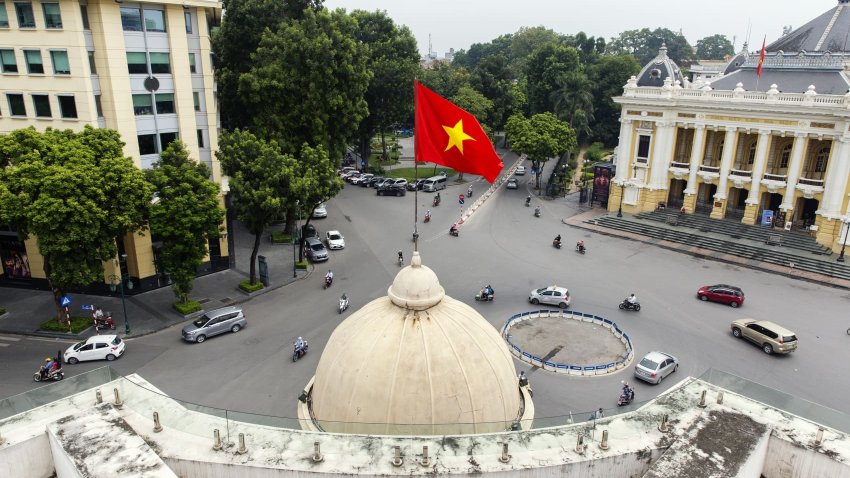 The Vietnamese flag flies atop the Hanoi Stock Exchange (HNX) in Hanoi, Vietnam, on Monday, Sept. 10, 2018.