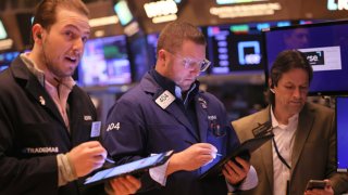 Traders work on the floor of the New York Stock Exchange during morning trading in New York City.