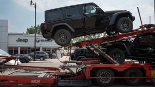 Jeep vehicles are delivered to a dealership on June 20, 2024 in Chicago, Illinois.