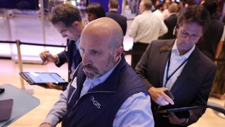 Traders work on the floor of the New York Stock Exchange during morning trading in New York City.