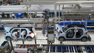 Employees work on an electric vehicle (EV) production line at the Leapmotor factory in Jinhua, China’s eastern Zhejiang province on September 18, 2024.