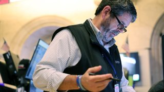 Traders work on the floor of the New York Stock Exchange during afternoon trading on October 03, 2024 in New York City.