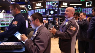 Traders work on the floor of the New York Stock Exchange during morning trading in New York City. 