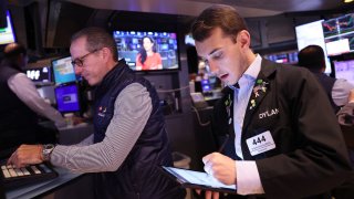 Traders work on the floor of the New York Stock Exchange during morning trading in New York City. 