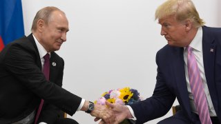 FILE – In this June 28, 2019, file photo, former President Donald Trump, right, shakes hands with Russian President Vladimir Putin, left, during a bilateral meeting on the sidelines of the G-20 summit in Osaka, Japan.