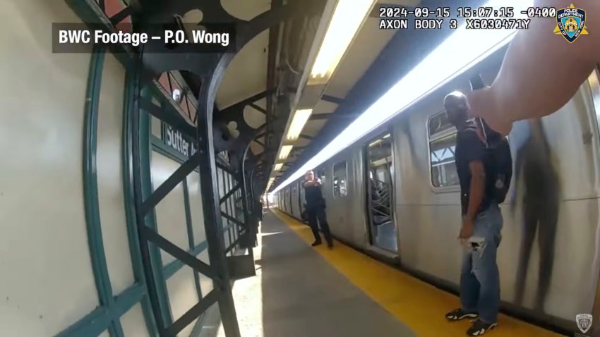 In this image from video provided by the New York Police Department, officers point their weapons towards Derell Mickles at the Sutter Avenue subway station in the Brownsville neighborhood of the Brooklyn borough of New York, on Sunday, Sept. 15, 2024.