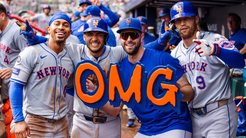 New York Mets’ Francisco Lindor, left, Jose Iglesias, left center, David Peterson, right center, and Brandon Nimmo, right, celebrate in the dugout after taking the lead in the eighth inning of a baseball game against the Atlanta Braves, Monday, Sept. 30, 2024, in Atlanta.