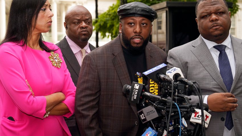 Shamel Kelly, center, flanked by his attorneys Bernarda Villalona, left, and Harry Daniels, right, speaks during a news conference in New York’s City Hall Park, Tuesday, Oct. 1, 2024.