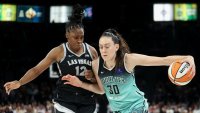 New York Liberty forward Breanna Stewart (30) drives past Las Vegas Aces guard Chelsea Gray (12) during the second half of a WNBA Semifinal basketball game, Sunday, Oct. 6, 2024, in Las Vegas. (AP Photo/Ian Maule)