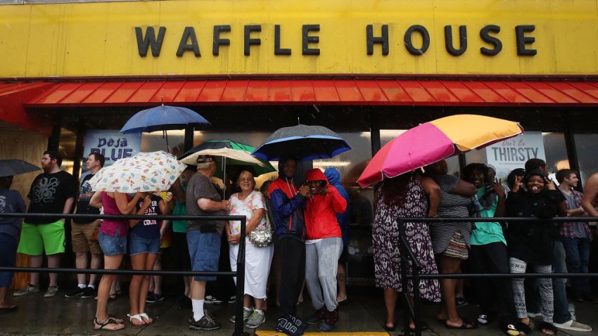 WILMINGTON, NC – SEPTEMBER 15: People wait in the rain to enter a Waffle House a day after Hurricane Florence hit the area, on September 15, 2018 in Wilmington, North Carolina. Hurricane Florence made landfall in North Carolina as a Category 1 storm Friday and at least five deaths have been attributed to the storm, which continues to produce heavy rain and strong winds extending out nearly 200 miles.  (Photo by Mark Wilson/Getty Images)