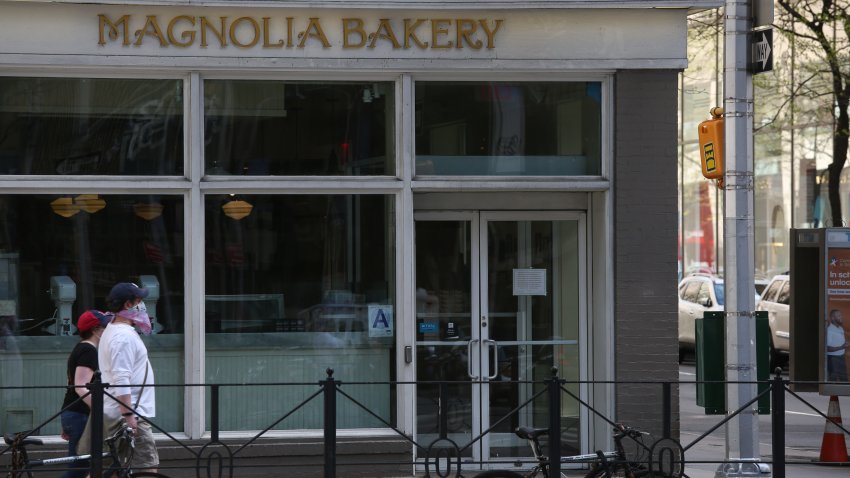 NEW YORK, NEW YORK – MAY 03: People walk by Magnolia Bakery during the coronavirus pandemic on May 3, 2020 in New York City.  COVID-19 has spread to most countries around the world, claiming over 248,000 lives and infecting more than 3.5 million people.