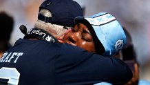 Head coach Mack Brown (L) of the North Carolina Tar Heels embraces September Craft