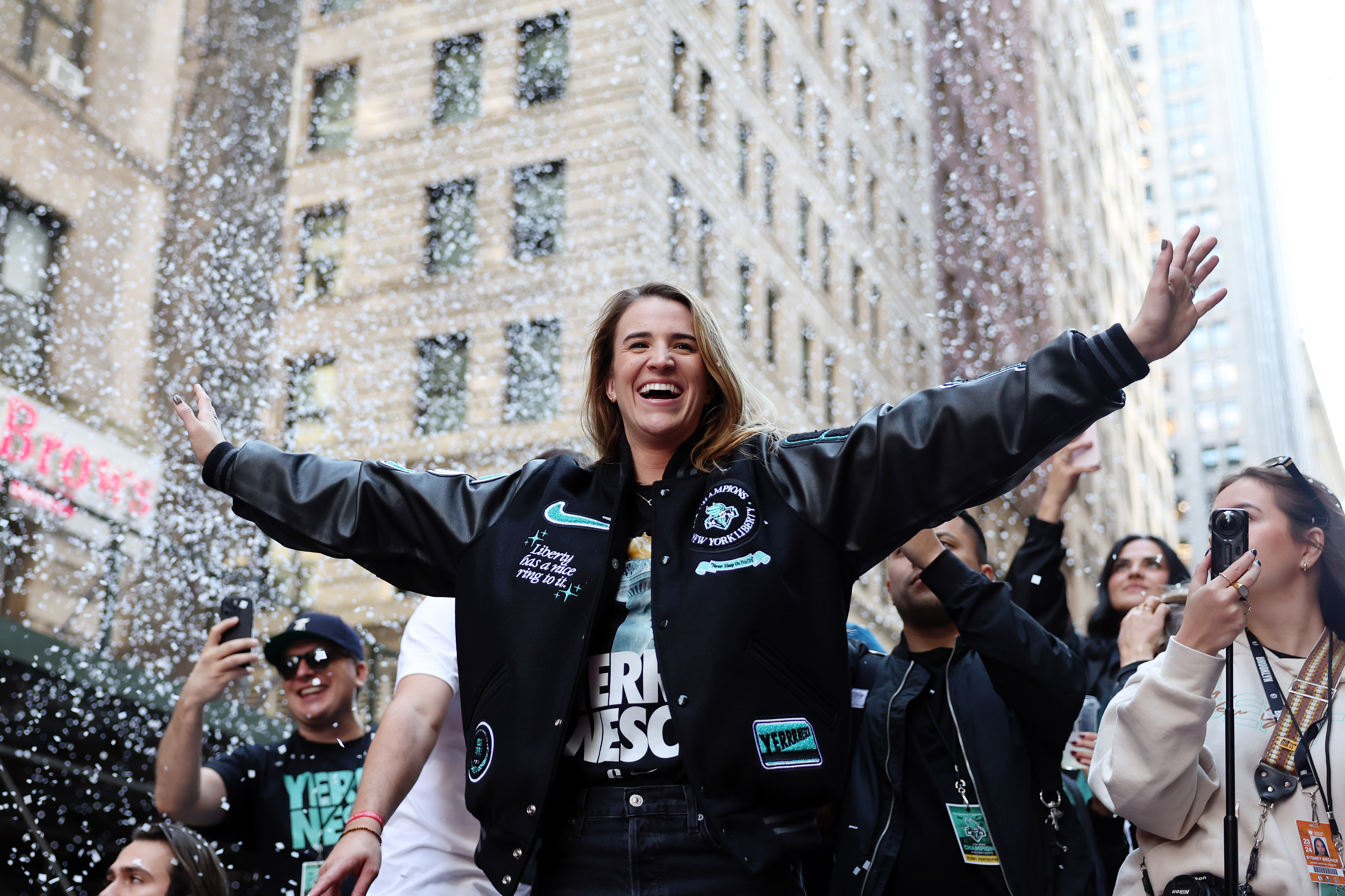 NEW YORK, NEW YORK – OCTOBER 24: Sabrina Ionescu #20 of the New York Liberty waves to the crowd during the New York Liberty Ticker Tape Victory Parade & Rally on October 24, 2024 in New York City. (Photo by Sarah Stier/Getty Images)