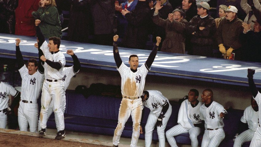 Baseball: World Series: New York Yankees Derek Jeter (2) victorious in front of dugout with teammates after Jim Leyritz home run vs Atlanta Braves at Yankee Stadium. Game 4.
Bronx, NY 10/27/1999
CREDIT: John Biever (Photo by John Biever /Sports Illustrated via Getty Images)
(Set Number: X59024 TK4 R9 F34 )